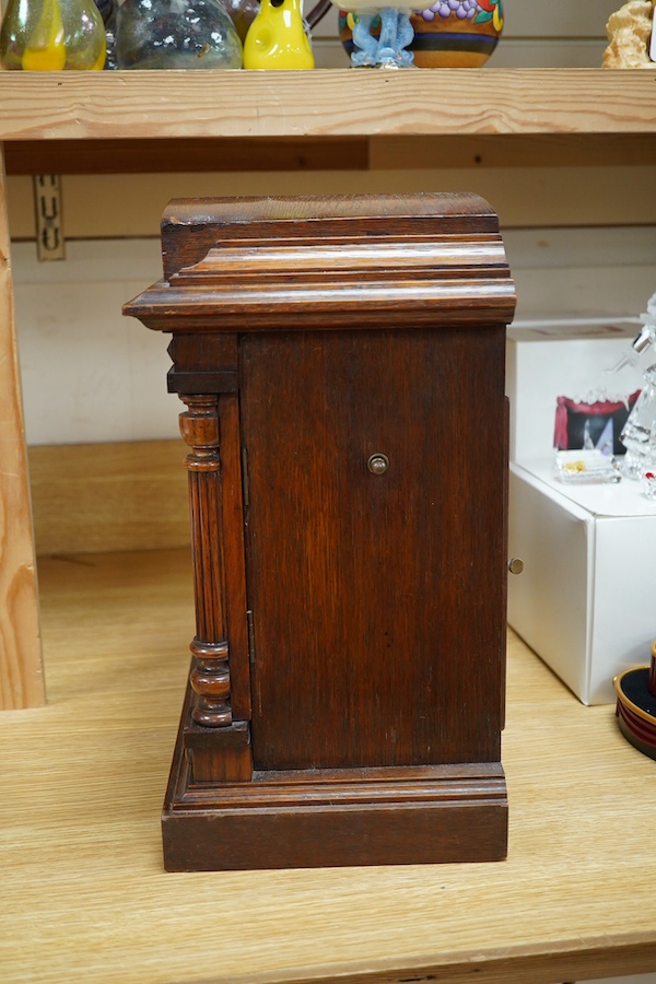 A late 19th century German oak three train mantel clock, 38.5cm high. Condition - fair, untested